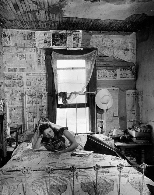 Alfred Eisenstaedt -- Young girl stretched on bed reading, 1942